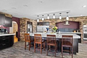 a kitchen with a kitchen island with chairs and a counter at River View Ranch 