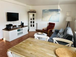 a living room with a couch and a tv at Neptun in Scharbeutz