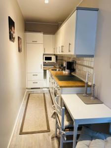 eine Küche mit weißen Schränken und einer blauen Arbeitsplatte in der Unterkunft Bellevue Nr. 17 in Scharbeutz