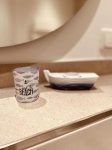 a coffee cup sitting on top of a counter at OceanHome in Scharbeutz