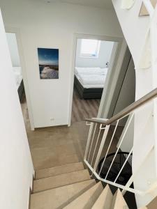 a staircase leading to a bedroom in a house at OceanHome in Scharbeutz