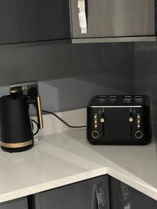 a black toaster sitting on top of a counter at Frank lane in Dewsbury