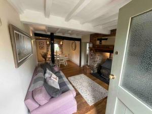 a living room with a couch and a fireplace at Ty Twty, Montgomery Cottage in Montgomery