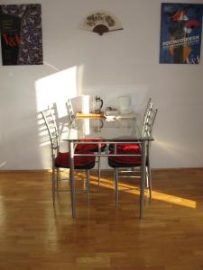 a glass table with four chairs and a table with a tea pot on it at Apartments Sopaljska 24a in Crikvenica +11 photos