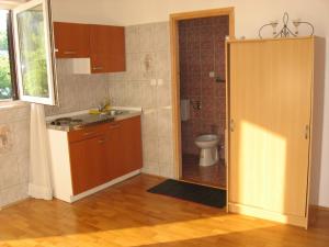 a kitchen with a sink and a toilet in a room at Apartments Sopaljska 24a in Crikvenica