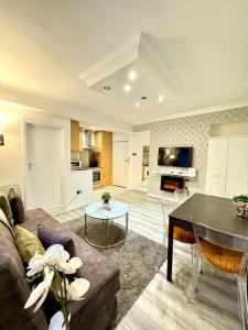 ein Wohnzimmer mit einem Sofa und einem Tisch in der Unterkunft Centrally-Located Gem in Marble Arch, London in London