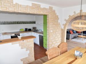 a kitchen and living room with a brick wall at NEU! Ferienhaus Schaaf in Hillscheid