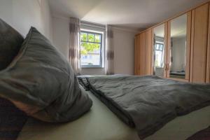 a bedroom with a bed with two pillows on it at NEU! Ferienwohnung Am Mühlberg in Selters