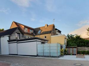 a large house with a white garage at NEU! Ferienhaus 54 Husum inkl Sauna in Husum