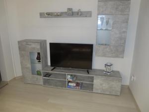 a large gray entertainment center with a flat screen tv at Neu Haus Koralle an der Nordsee in Dornumergrode