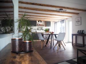 a kitchen and dining room with a table and chairs at FeWo Westerwaelder Höhenluft in Langenbach bei Kirburg