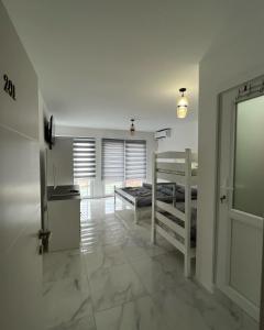 a bedroom with two bunk beds and a window at Hotel 7 Arians's in Peje