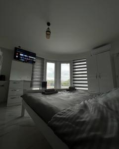 a bedroom with a large bed in front of windows at Hotel 7 Arians's in Peje +6 photos