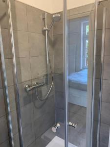 a shower with a glass door in a bathroom at NEU Küstenliebe Friesland in Varel