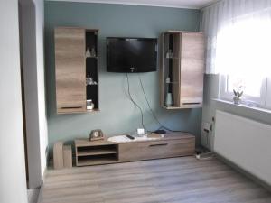 a living room with a flat screen tv on the wall at Ferienhaus am Rheinsteig in Kaub
