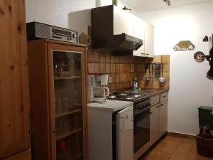 a kitchen with a stove and a refrigerator at NEU! Fewo Küstenstube in Schweiburg