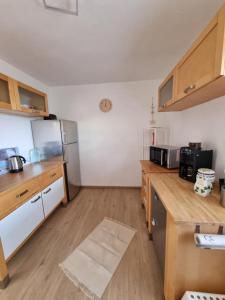 a kitchen with a stainless steel refrigerator and wooden counters at Ferienhaus Am Zollhaus in Teplingen +16 photos