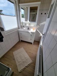 a bathroom with a sink and a mirror at Ferienhaus Am Zollhaus 