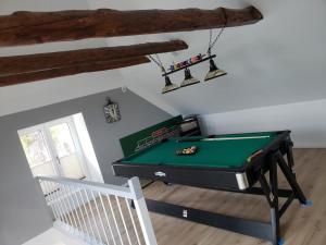 una mesa de billar en una sala de estar con techo en Ferienhaus Kastanie mit Whirlpool Kamin und Sauna, en Blekendorf
