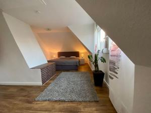a attic room with a bed and a staircase at NEU Ferienwohnung Walsrode in Walsrode