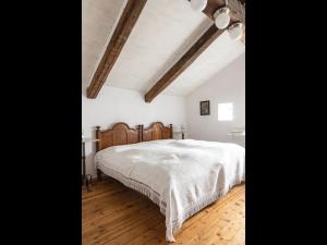 a bedroom with a white bed and a wooden floor at NEU ! Ferienwohnung Beim Kirschschuster in Schernfeld