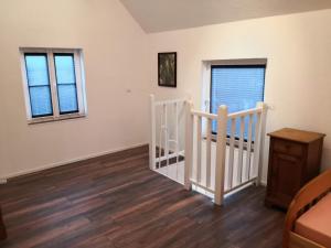 a bedroom with a crib and two windows at NEU! Schicke FeWo Alsfeld in Alsfeld +7 photos