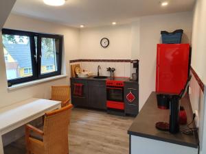 a kitchen with a red refrigerator and a red stove at NEU! Ferienwohnung Walnusstraum in Plaaz