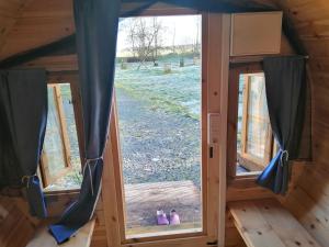 a view from inside a tiny house with two windows at NEU! Campingfass Milchschafhof in Bremervörde