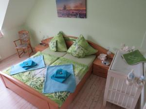 a bedroom with a bed with blue towels on it at FeWo Bergstadt Ehrenfriedersdorf in Ehrenfriedersdorf