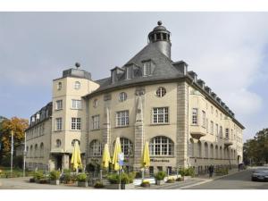 a large building with yellow umbrellas in front of it at NEU! FeWo History Aschersleben in Aschersleben
