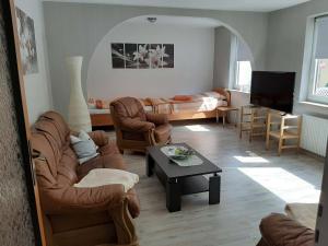 a living room with two couches and a table at NEU! Ferienwohnung Teichblick in Bad Grund in Bad Grund