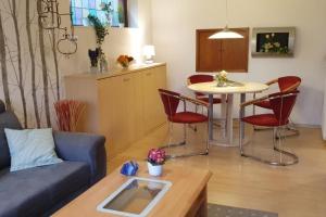a living room with a couch and a table at NEU! Ferienwohnung Ramke EG in Lilienthal