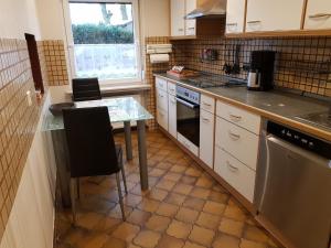 a kitchen with a table and a stove top oven at NEU! Ferienwohnung Ramke EG in Lilienthal +3 photos
