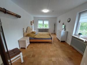 a bedroom with a bed and a chair in it at NEU Ferienwohnung Lottje in Dannewerk