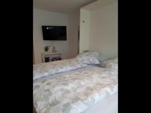 a bed with a white comforter in a bedroom at NEU! Ferienwohnung Mien lütte Boe SPO in Sankt Peter-Ording