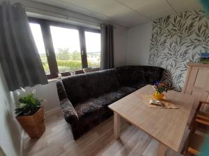 a living room with a couch and a table at NEU Apartment Hanka in Crostwitz