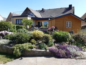 a house with a garden of flowers in front of it at NEU Apartment Hanka in Crostwitz