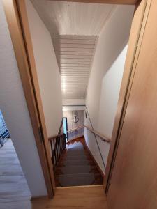 a hallway with a staircase in a house at NEU! Fewo Merle mit Balkon in Carolinensiel