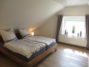 Postel nebo postele na pokoji v ubytování NEU! Landhaus Lüttje Nüst
