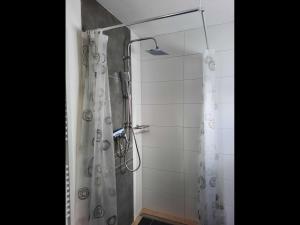 a shower with a shower curtain in a bathroom at NEU! Ferienwohnung Lucie in Kevelaer