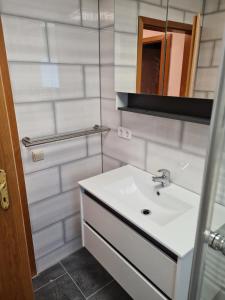 a white bathroom with a sink and a mirror at NEU! Ferienwohnung Muecheln Geiseltal in Mücheln