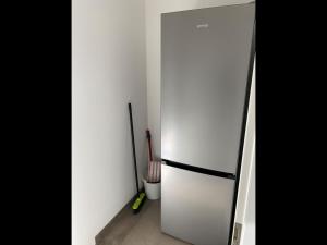 a white refrigerator in a room with tools at NEU! Ferienwohnung MOIN in Langwedel