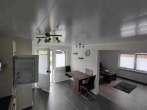 a living room with a table and a tv at NEU Ferienwohnung Wildgans Dollart Ostfriesland in Bunde +3 photos