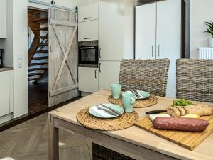 a kitchen with a wooden table with food on it at Ferienwohnung Meer und Muh in Strenglin