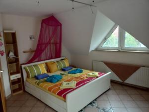 a bedroom with a bed with a pink curtain at NEU Ferienhaus mit Poolhalle und Sauna in Pyrbaum