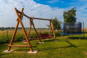 a playground with a swing set and a nets at NEU! Ritterherberge zum Falken in Falkenhagen