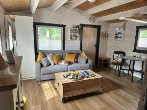 a living room with a couch and a coffee table at NEU! Ferienhütte Tiny House in Schöningen