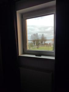 a window in a room with a view of a field at FeWo Franja Angermünde in Angermünde