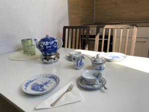 a table with blue and white china on it at NEU! FeWo am alten Deich mit Balkon in Osteel