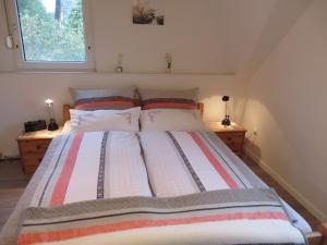 a bedroom with a large bed with two night stands at NEU Ferienwohnung Wellenrauschen in Westerholt
